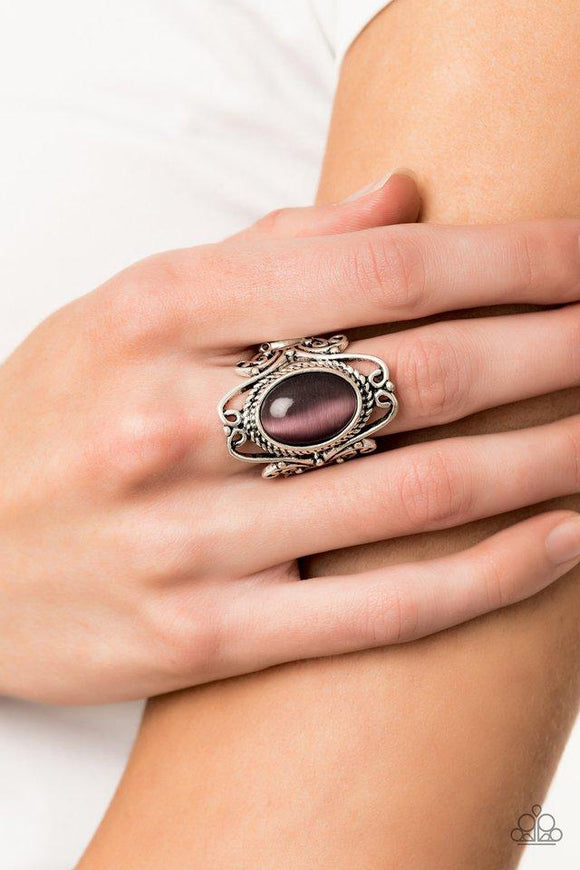 Paparazzi Fairytale Flair - Purple - 2019 Convention Exclusive
A glowing purple cat's eye stone is nestled inside of an airy silver frame radiating with frilly filigree for a whimsical look atop the finger. Features a stretchy band for a flexible fit.
