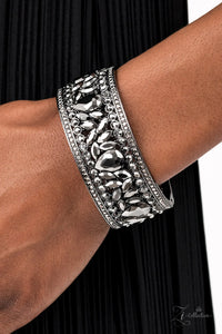 Paparazzi After Party Powerhouse - Zi Bracelet - A smoldering collection of oversized teardrop and marquise cut hematite rhinestones haphazardly coalesce between linear stacked rows of round hematite rhinestones. The dazzling hematite spangled gunmetal frames regally connect around the wrist, creating a bold bangle-like cuff. Features an adjustable hinged closure.  Sold as one individual bracelet.