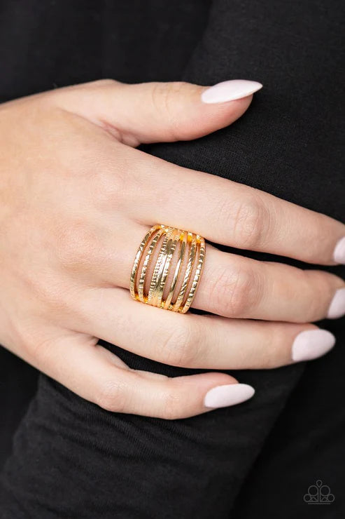 Paparazzi Basic Maverick - Gold Ring - A collection of smooth and textured gold bars arc across the finger, stacking into a thick layered band. Features a stretchy band for a flexible fit.