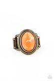Paparazzi Cliff Dweller Demure - Brass Orange Ring - An oval orange stone is pressed into the center of a stacked brass frame, creating an earthy centerpiece atop the finger. Features a stretchy band for a flexible fit.