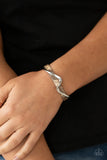 Paparazzi Craveable Curves - Brown Bracelet - A flat silver bar delicately curls across a dainty brown shell-like acrylic cuff, creating a whimsical centerpiece around the wrist.