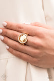 Paparazzi Crown Culture - Gold Ring - An oversized champagne gem is bordered by traditional white rhinestones. The heirloom-esque presence gives a nod to grandmother's jewelry box as it catches the eye and requests a second look. Features a stretchy band for a flexible fit.