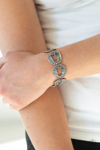 Paparazzi Cut It Out - Silver Bracelet - Featuring asymmetrical cutout centers, textured silver discs connect across the wrist for an abstract look. Features an adjustable clasp closure.
