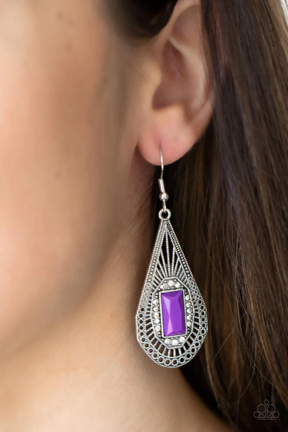 Paparazzi Deco Dreaming - Purple Earrings - A bright purple baguette-cut bead, bordered with sparkling white rhinestones, sits center stage inside a teardrop frame. Delicate art deco filigree fills the frame creating a richly embellished lure. Earring attaches to a standard fishhook fitting.