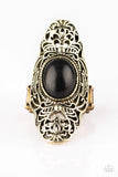 Dotted with an earthy black stone center, glistening brass filigree climbs the finger, coalescing into a dramatic frame. Features a stretchy band for a flexible fit. 