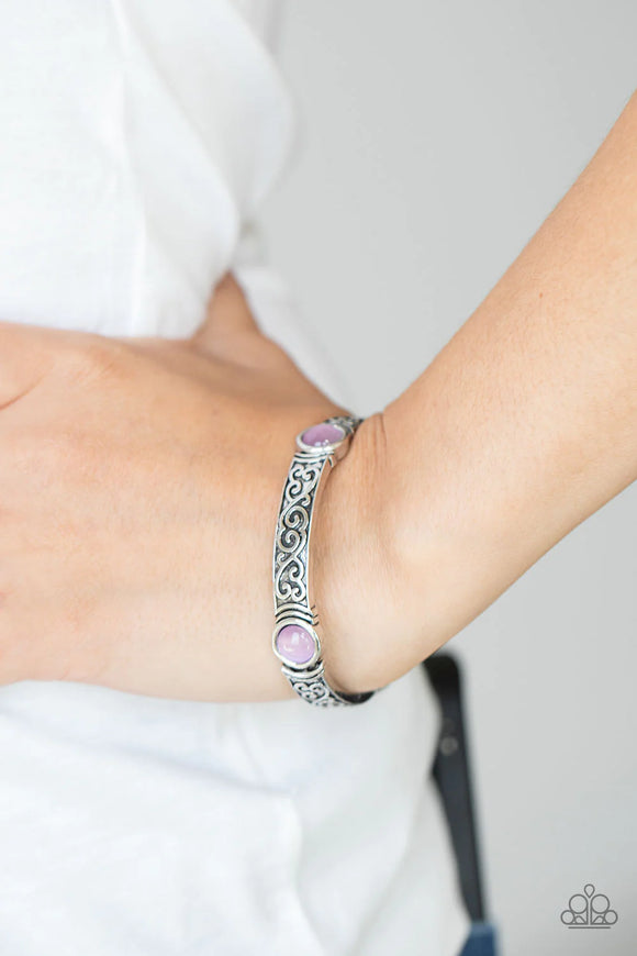 Paparazzi Ethereally Enchanting - Purple Bracelet - A purple cat's eye stone is pressed into a round frame at the end of a silver bar. Embossed with a whimsical vine motif, the patterned bars are threaded on stretchy bands to repeat around the wrist for an enchanting finish.