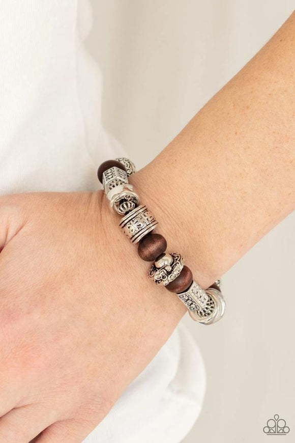 Paparazzi Exploring The Elements - Brown Bracelet - Stamped, studded, and embossed in tribal inspired patterns, a collection of chunky silver beads join earthy wooden beads along a stretchy band around the wrist for an earthy flair.