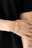 Paparazzi Filigree Fiesta - Gold Bracelet - Shiny rose gold filigree swirls into a round frame that hooks to a dainty rose gold bangle-like cuff, creating a whimsical centerpiece. Features a hinge-like closure.