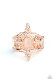 Paparazzi Fleur De Fancy - Rose Gold Ring - Dotted with dainty white rhinestones, leafy floral frames bloom from the center of a peach cat's eye stone center, adding hints of shimmer to the whimsically layered bands. Features a stretchy band for a flexible fit.
