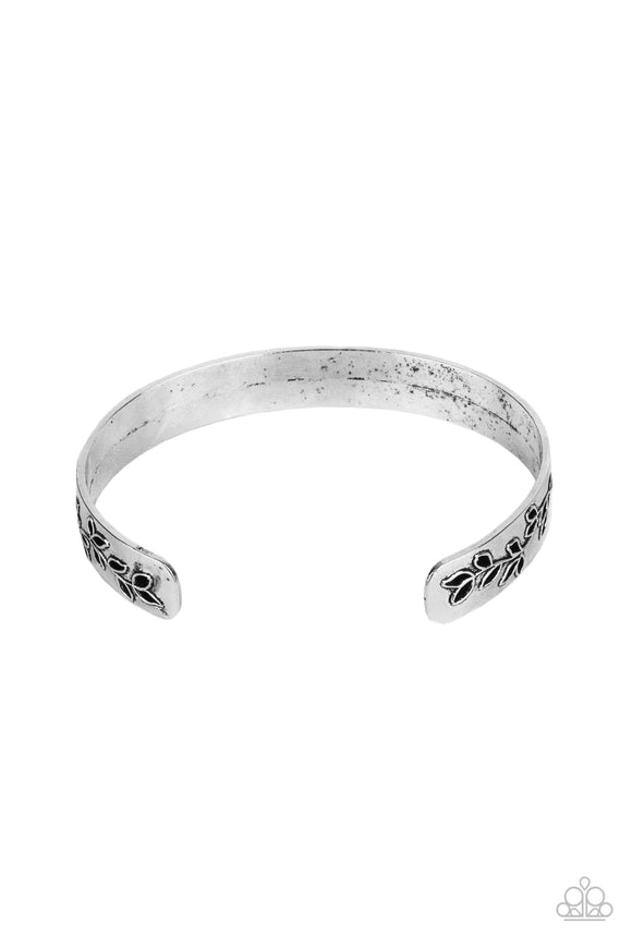 Paparazzi Frond Fable - Silver Bracelet - The ends of a dainty silver cuff are cutout and embossed in leafy filigree, creating a simple seasonal centerpiece around the wrist.