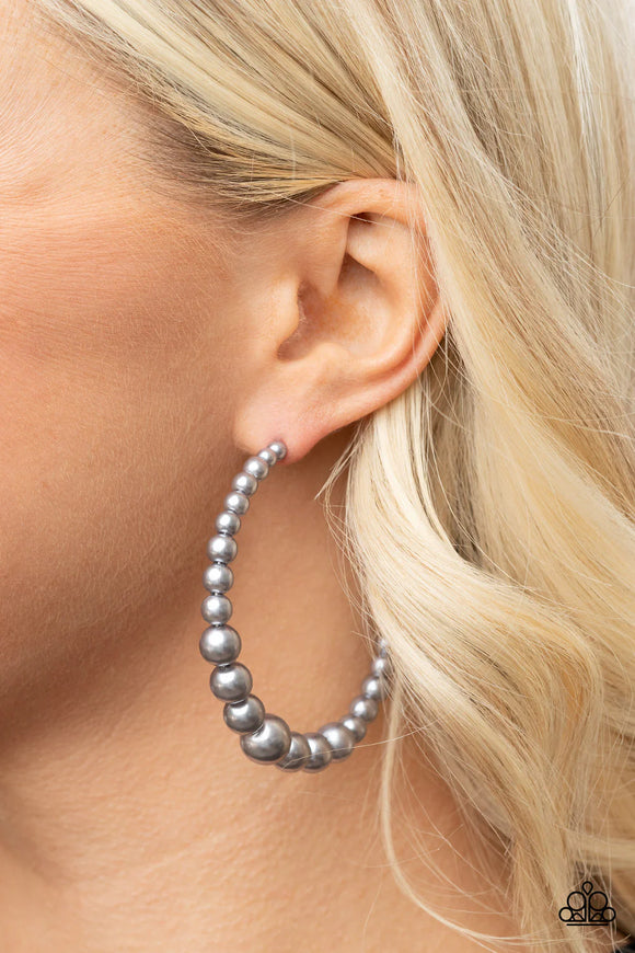 Paparazzi Glamour Graduate - Silver Earrings - Gradually increasing in size at the center, a classic row of pearly silver beads are threaded along an oversized hoop for a posh finish. Earring attaches to a standard post fitting. Hoop measures approximately 2 1/4