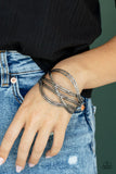 Paparazzi Hautely Hammered - Black Gunmetal Bracelet - Brushed in an antiqued shimmer, hammered out pieces of flat gunmetal bars decoratively weave into a curved cuff around the wrist for an intense industrial finish.