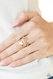 Paparazzi Heart String Harmony - Gold Ring - A glistening gold ribbon spells out the word, "love," atop a gold band dotted with a dainty gold heart center for a charmingly stacked look. Features a stretchy band for a flexible fit.