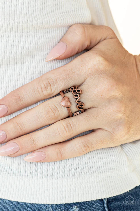 Paparazzi Heartstring Harmony - Copper Ring - Brushed in an antiqued shimmer, a glistening copper ribbon spells out the word, 