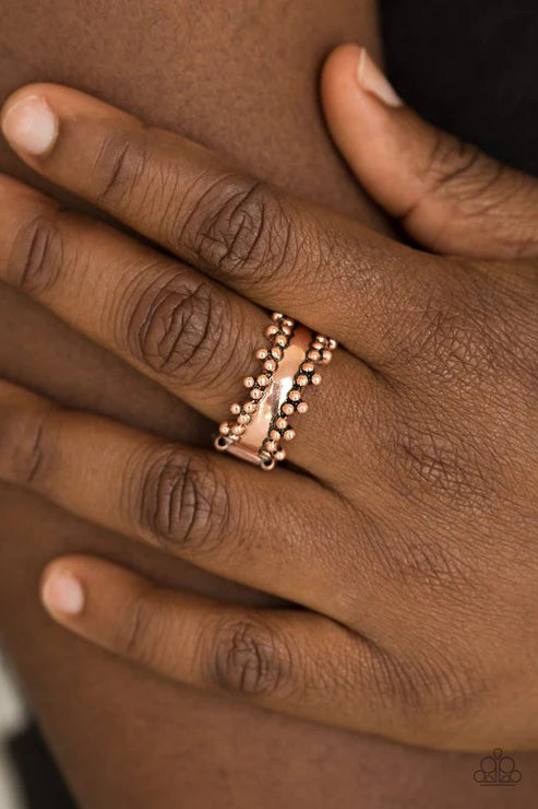Paparazzi Heavy Metal Muse - Copper Ring - Trios of shimmery copper studs dot the top and bottom of an antiqued copper band for an edgy industrial look. Features a dainty stretchy band for a flexible fit.