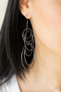 Paparazzi I Feel Dizzy - Black Gunmetal Earrings - Varying in size, a shiny collection of mismatched gunmetal hoops haphazardly connect into a dizzying lure. Earring attaches to a standard fishhook fitting.