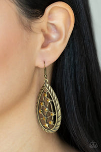 Paparazzi Industrial Incandescence - Brass Earrings - A gritty collection of dainty aurum rhinestones adorn hammered brass bars streaking across the airy center of an antiqued textured teardrop, creating a rustic fashion. Earring attaches to a standard fishhook fitting.