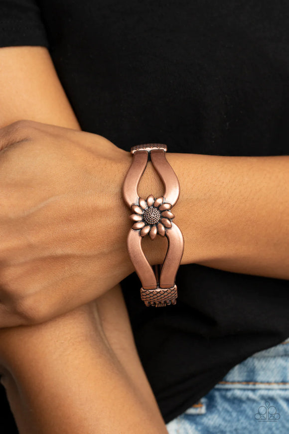 Paparazzi Let A Hundred SUNFLOWERS Bloom - Copper Bracelet - Antiqued copper ribbons loop out from a decorative copper sunflower that attaches to a ribbed copper frame, creating a cuff-like bangle around the wrist. Features a hinged closure.
