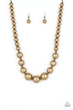 Paparazzi Living Up To Reputation - Brass Necklace - A collection of bold brass beads are threaded along an invisible wire below the collar. The antiqued beads dramatically increase in size as they reach the center for an undeniable statement-making finish. Features an adjustable clasp closure.