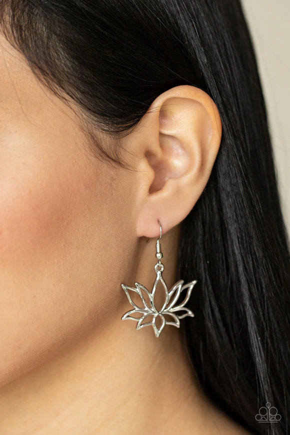 Brushed in a high sheen shimmer, an oversized silver lotus swings from the ear for a seasonal fashion. Earring attaches to a standard fishhook fitting.
