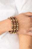 Held together with dainty brass fittings, rows of faceted brass, copper, and gold beads are threaded along stretchy bands around the wrist, coalescing into bold layers.