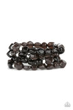 Paparazzi Nice GLOWING - Black Bracelet - Glossy black irregularly shaped beads in varying opacities, accented with shining faceted silver beads are threaded along stretchy bands and stack up the wrist for a glowing display.