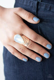 Paparazzi Opal Mist - Gold Ring - Featuring a milky iridescence, the tip of a glassy white teardrop attaches to a studded rose gold band. The bottom of the ethereal teardrop drips down towards the knuckles, creating a bold, one-of-a-kind statement piece. Features a stretchy band for a flexible fit.