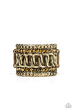 Paparazzi Out For The Count - Brass Ring - Flanked by stacks of brass studs and aurum rhinestones, interlocking brass links race down the center of an edgy band for a knockout finish. Features a stretchy band for a flexible fit.