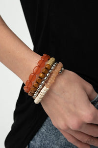 Paparazzi Outdoor Retreat - Multi Bracelet - An earthy collection of wooden cubes, opaque Rust acrylic ovals, wavy Willow accents, tranquil Desert Mist pebble-like accents, classic silver beads, and silver chevron frames are threaded along a long wire to create a whimsical infinity wrap bracelet around the wrist.