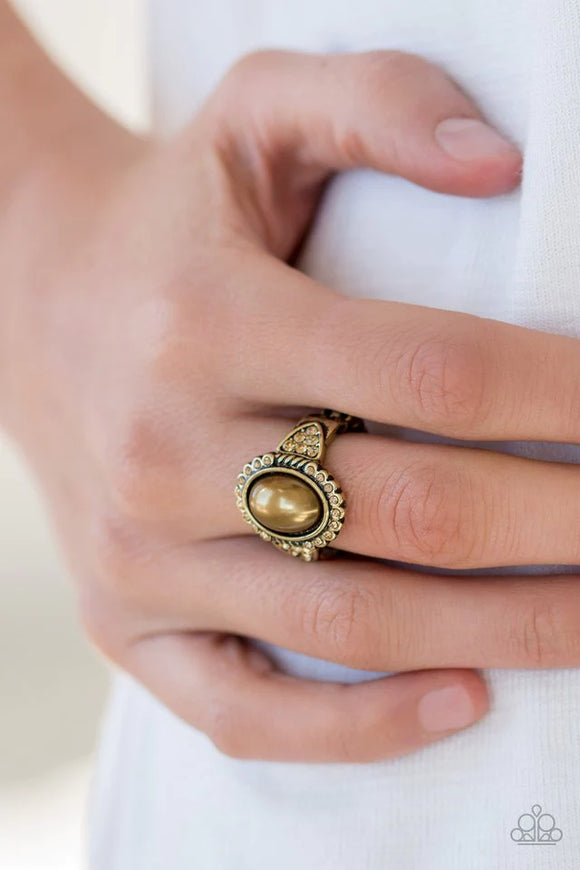 Paparazzi Pearl Party - Brass Ring - A pearly brass bead is pressed into the center of an ornate brass frame radiating with golden topaz rhinestones for a refined look. Features a stretchy band for a flexible fit. Sold as one individual ring.