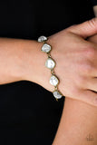 Paparazzi Perfect Imperfection - Brass Bracelet - Featuring antiqued brass frames, imperfect glassy white gems link around the wrist for a glamorous vintage inspired look. Features an adjustable clasp closure.