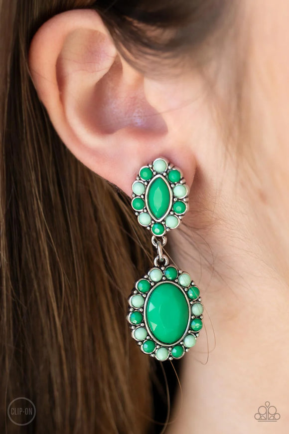 Paparazzi Positively Pampered - Green Clip-On Earrings - Bordered in dainty Mint and Green Ash beads, a pair of marquise and oval Mint beads delicately link into a colorful lure for a fresh pop of color. Earring attaches to a standard clip-on fitting.