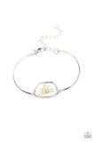 Paparazzi Prairie Paradise - White Bracelet - Encased inside an asymmetrical glass casing, a dainty white firework flower centerpiece attaches to two arcing silver bars around the wrist for a whimsical floral look. Features an adjustable clasp closure.