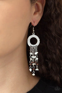 Paparazzi Primal Prestige - White Earrings - Tapered tassels of dainty wooden beads and white pebbles stream from the bottom of a hammered silver hoop, creating an earthy fringe. Earring attaches to a standard fishhook fitting.