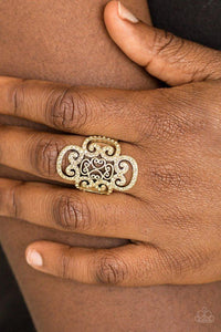 Paparazzi Regal Regalia - Brass Ring - Dainty topaz rhinestones are encrusted along a glistening brass frame radiating with regal filigree for a refined look. Features a stretchy band for a flexible fit.