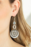 Paparazzi Royal Marina - White Earrings - Reminiscent of an eclipse, an airy silver ring radiating with ornate petals, sways in front of a white shell-like disc. Silver rings in graduating sizes cascade from the top for a whimsically nautical look. Earring attaches to a standard fishhook fitting.