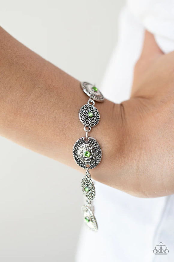 Paparazzi Secret Garden Glamour - Green Bracelet - Delicate Peridot rhinestones dot the centers of engraved antiqued silver discs. The dotted textures and heart shaped vines create a charming impression as they gracefully link around the wrist. Features an adjustable clasp closure.
