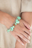 Paparazzi Springtime Springs - Green Bracelet - Infused with wooden beads and silver discs, an earthy collection of glassy, opaque, and shell-like Green Ash beads swing from the wrist, creating a springtime inspired fringe. Features an adjustable clasp closure.