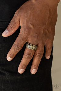 Paparazzi Survival Skills - Brass Ring - Brushed in an antiqued finish, stacked rows of chevron-like patterns are etched and embossed across a thick brass band for a tactile look. Features a stretchy band for a flexible fit.
