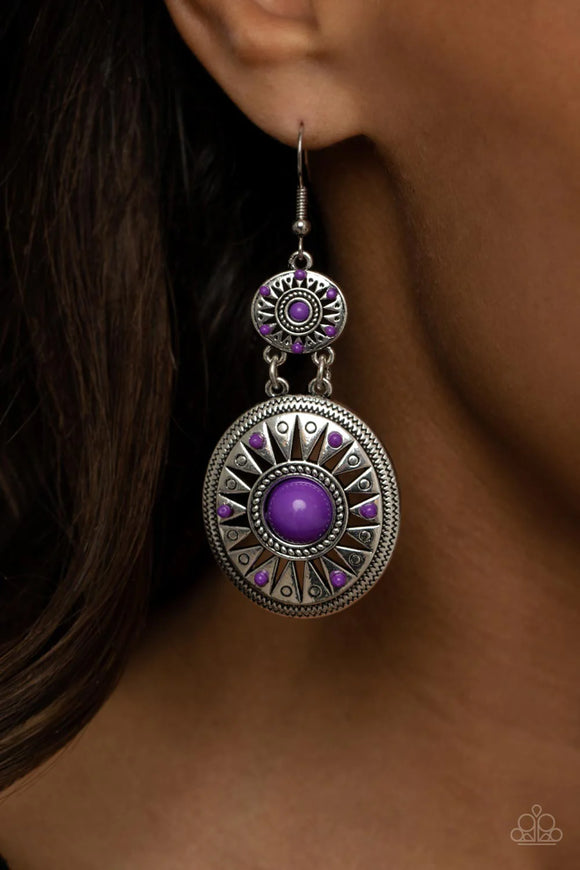 Paparazzi Temple Of The Sun - Purple Earrings - Dotted with bubbly purple beaded accents, two silver frames that have been stenciled in airy sunburst patterns that delicately link into a colorful tribal inspired lure. Earring attaches to a standard fishhook fitting.