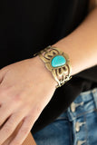 Paparazzi The Mesas Are Calling - Brass Bracelet - An asymmetrical turquoise stone is pressed into the center of a brass cuff layered with filigree patterns around the wrist for a rustic flair.