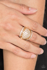 Paparazzi The Seven FIGURE Itch - Gold Ring - Encrusted in row after row of blinding white rhinestones, two dainty gold bands flank a thick gold band for a statement-making look. Features a stretchy band for a flexible fit.