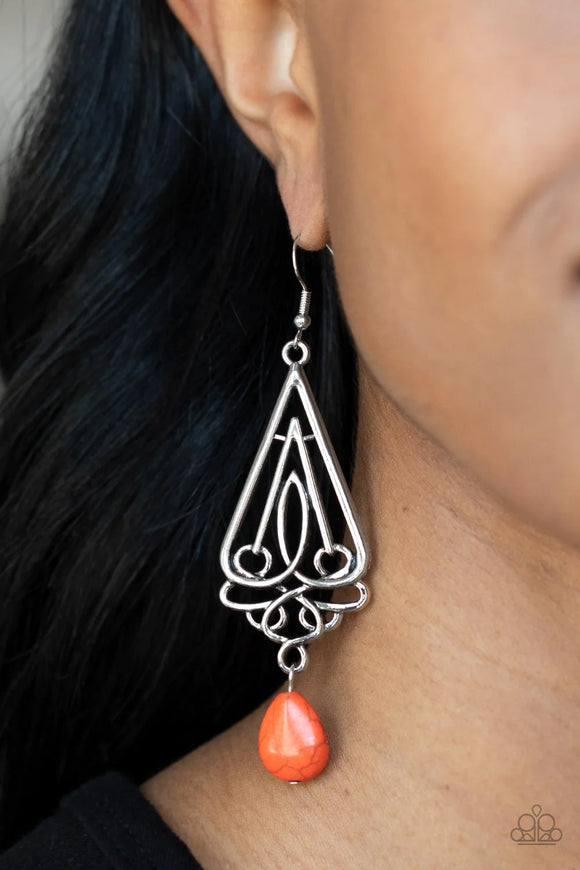 Paparazzi Transcendent Trendsetter - Orange Earrings - A refreshing orange teardrop stone swings from the bottom of an ornate triangular frame, creating a seasonal statement. Earring attaches to a standard fishhook fitting.