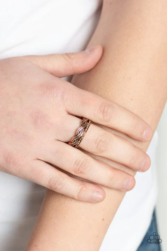 Paparazzi Unstoppable Shine - Copper Ring - Dotted in glistening copper studs, dainty copper bands weave across the finger. A topaz rhinestone encrusted band arcs across the bottom for a refined finish. Features a dainty stretchy band for a flexible fit.