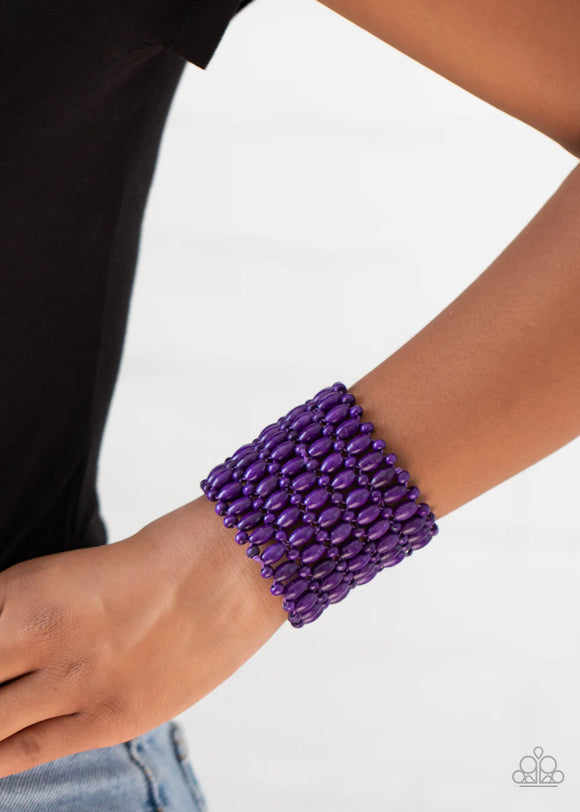 Paparazzi Way Down In Kokomo - Purple Bracelet - Round and oval purple wooden beads are threaded along stretchy bands that intricately weave around the wrist, coalescing into a colorful stretch bracelet.