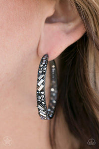 Paparazzi Blockbuster GLITZY By Association - Black
The front facing surface of a chunky gunmetal hoop is dipped in brilliantly sparkling hematite rhinestones while light-catching texture wraps around the back. The interior of the hoop features the opposite pattern, creating the illusion of a full hoop of blinding shimmer. Earring attaches to a standard post fitting. Hoop measures 1 3/4" in diameter.
