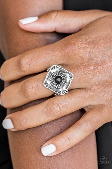 Paparazzi Four Corners Fashion - Black Embossed and studded in tribal inspired patterns, a tilted square frame sits atop the finger. A black stone dots the center of the frame for a seasonal finish. Features a stretchy band for a flexible fit.
