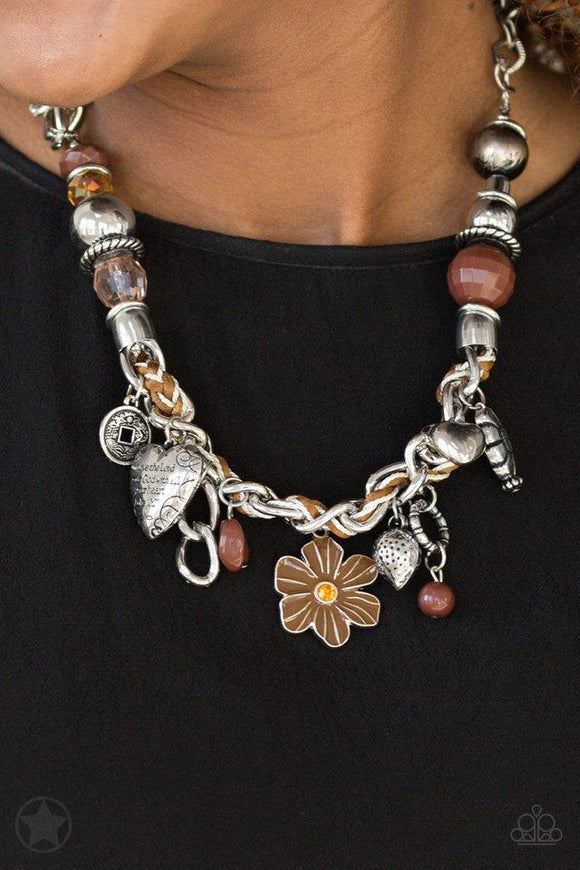 Paparazzi Charmed I Am Sure - Brown Brown and ivory cording is braided through a chunky silver chain. A unique variety of charms decorate the piece including a delicate flower and a heart inscribed with the phrase 