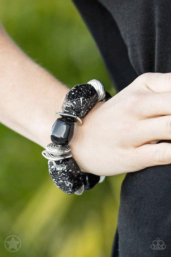 Paparazzi Glaze of Glory - Black Chunky black beads with speckles of silver and a gorgeous glazed finish are threaded along a stretchy band with thick silver rings.
