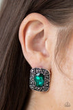 Paparazzi Young Money - Green - Earrings  -  An oval green gem is pressed into a square silver frame radiating with glittery hematite rhinestones and triangular patterns for an edgy refinement. Earring attaches to a standard post fitting.
